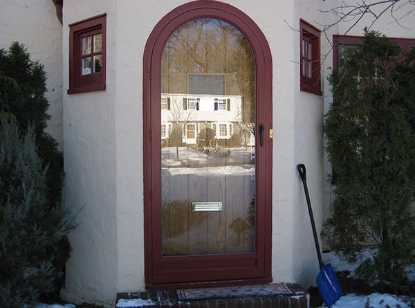 Full view glass storm door, customized by Screenmobile to cover and arched doorway