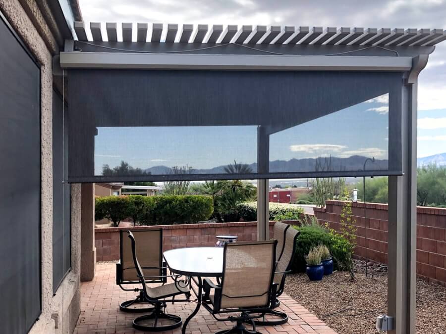A small outdoor patio with retractable shades for sun control and comfort