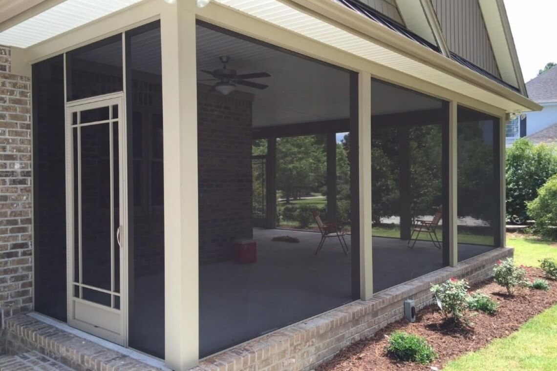A white framed screened in porch enclosure.