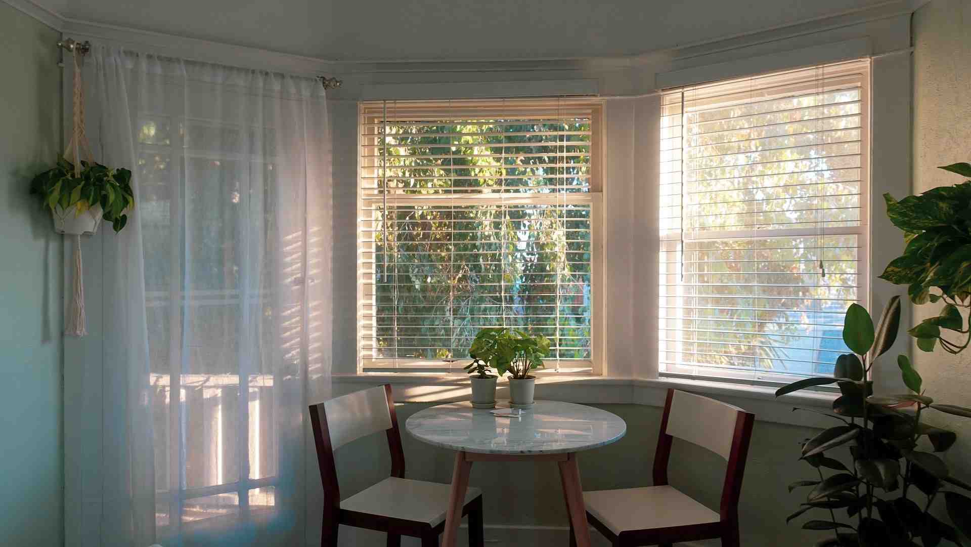 Breakfast nook with a bay windows and white blinds