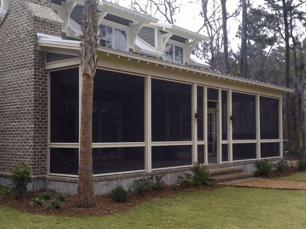 A front patio is transformed into a screened in patio using multiple screen panels.