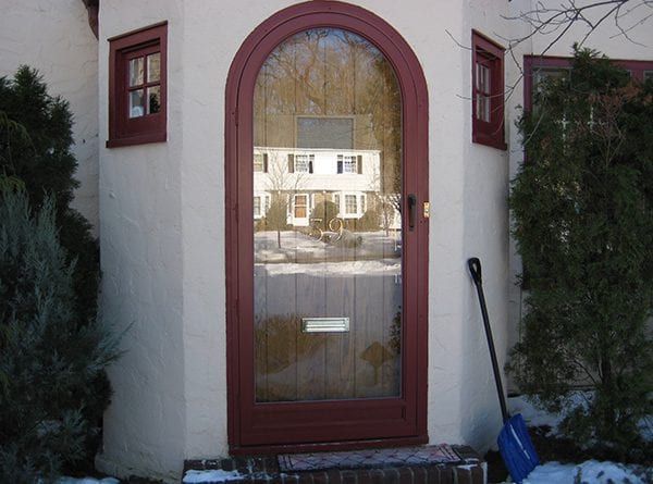 home with a custom arched storm door entryway