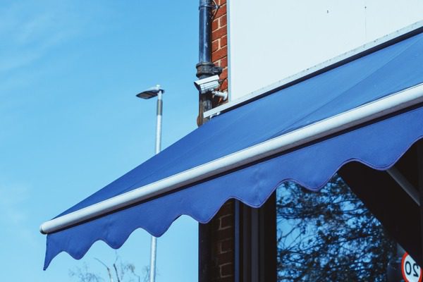 blue retractable awning on a commercial building