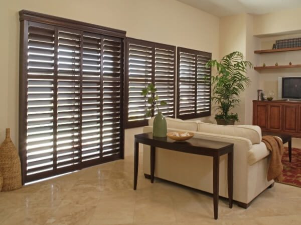 Living room with a focus on dark wood window shutters
